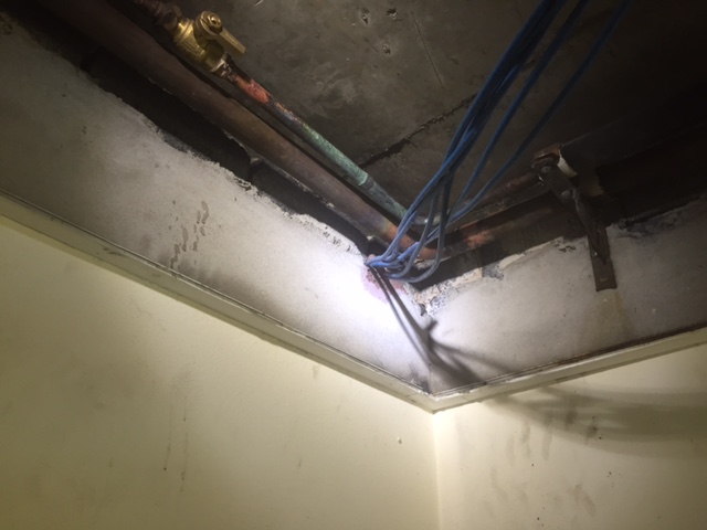 We ran the new 40mm copper pipe into the false ceiling space of the unit below, joining onto another newer section of 40mm copper pipe. 