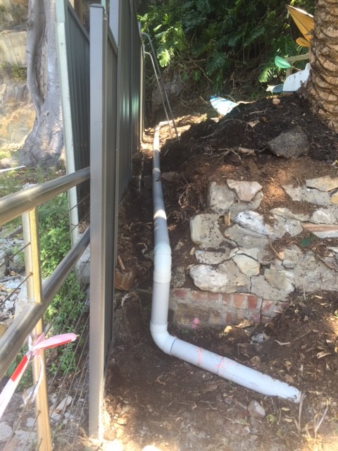 We excavated and moved the pipe away from the fence and replaced the damaged section.