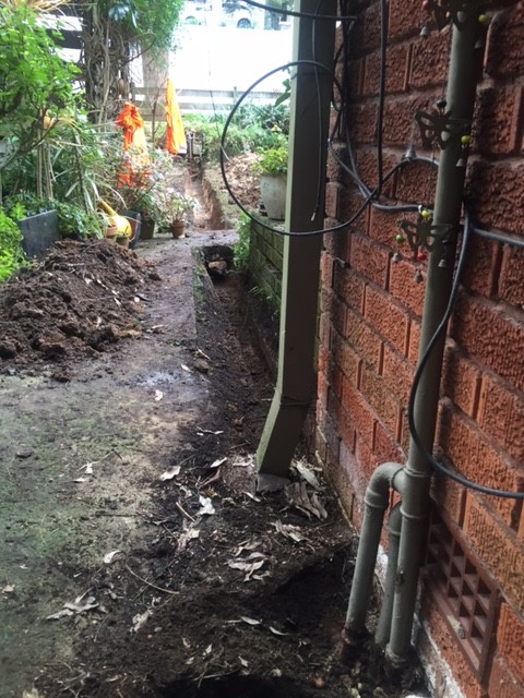 We hand excavated from the gas meters at the front of the property through to the right hand side of the building.